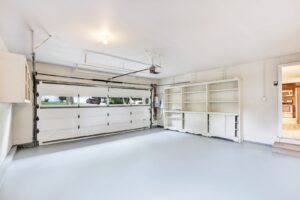 Clean garage with white storage cabinets and shelving ready for Valley snowbird season
